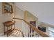Hallway with a wooden railing, side table, and shelving at 1870 Broadleaf Ct # 10, Greenwood, IN 46143
