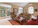 Inviting living room with french doors, a ceiling fan, comfortable seating, and a stylish glass coffee table at 1870 Broadleaf Ct # 10, Greenwood, IN 46143