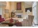 Bright living room featuring a stone fireplace, mantel, a large window, and comfortable seating for relaxation at 1870 Broadleaf Ct # 10, Greenwood, IN 46143