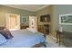 Comfortable main bedroom with hardwood furniture, TV, and closet doors in view at 1870 Broadleaf Ct # 10, Greenwood, IN 46143