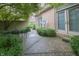 Charming brick patio with lush landscaping, a decorative metal table set, and easy access through glass doors at 1870 Broadleaf Ct # 10, Greenwood, IN 46143