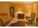 Inviting sitting room with a vintage couch, accent chair, and decorative lamps at 1870 Broadleaf Ct # 10, Greenwood, IN 46143