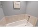 Relaxing bathroom features a soaking tub with beige tiled walls at 1870 Broadleaf Ct # 10, Greenwood, IN 46143