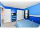 Bright bedroom features blue accent wall, gray carpet, and window at 2020 Treving Dr, Cicero, IN 46034