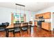 Dining area with wooden floors and matching table adjacent to the kitchen, filled with natural light at 2020 Treving Dr, Cicero, IN 46034