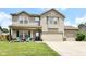 Charming two-story home with a well-manicured lawn, inviting front porch, and a convenient two-car garage at 2020 Treving Dr, Cicero, IN 46034