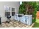Outdoor grilling area with a modern grill, built-in counter space, and a paved patio at 2020 Treving Dr, Cicero, IN 46034
