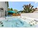 Backyard hot tub with jets, with an umbrella and pergola in a peaceful outdoor space at 2020 Treving Dr, Cicero, IN 46034