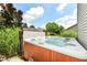 Relax in this backyard hot tub, surrounded by privacy landscaping and under the beautiful blue sky at 2020 Treving Dr, Cicero, IN 46034