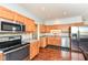Well-equipped kitchen with stainless steel appliances, modern cabinets, and hardwood floors at 2020 Treving Dr, Cicero, IN 46034