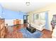 Inviting living room with hardwood floors, accent wall and natural light from the windows at 2020 Treving Dr, Cicero, IN 46034