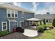 The backyard showcases a covered patio, blue siding, and well-kept landscaping at 21491 Raccoon Ct, Noblesville, IN 46062