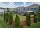 Aerial view of a fenced backyard featuring a lush green lawn, garden, and covered patio at 21491 Raccoon Ct, Noblesville, IN 46062