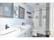Elegant bathroom with double sinks, decorative mirrors, tiled shower and tub at 21491 Raccoon Ct, Noblesville, IN 46062