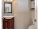 Charming bathroom with a decorative mirror, wooden vanity and faucet, with toilet seat visible in the background at 21491 Raccoon Ct, Noblesville, IN 46062