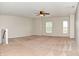 Spacious bedroom featuring neutral walls, plush carpeting, ceiling fan, and windows at 21491 Raccoon Ct, Noblesville, IN 46062