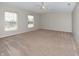 Spacious bedroom with carpeted floor, ceiling fan, and natural light from the windows at 21491 Raccoon Ct, Noblesville, IN 46062