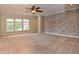 Spacious bonus room with carpet, exposed brick wall, ceiling fan, and ample natural light at 21491 Raccoon Ct, Noblesville, IN 46062