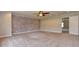 Bonus room with carpet, exposed brick wall, ceiling fan and a nearby doorway at 21491 Raccoon Ct, Noblesville, IN 46062
