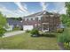 A brick two-story home with a manicured lawn and long driveway, perfect for Gathering living at 21491 Raccoon Ct, Noblesville, IN 46062