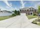 Inviting brick two-story home with a manicured lawn, long driveway, and attached two-car garage at 21491 Raccoon Ct, Noblesville, IN 46062