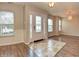 Bright foyer with tiled entrance, hardwood floors, and a decorative front door with sidelights at 21491 Raccoon Ct, Noblesville, IN 46062