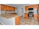Gourmet kitchen featuring granite countertops, a breakfast bar, and modern appliances at 21491 Raccoon Ct, Noblesville, IN 46062