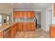 Bright kitchen featuring stainless steel appliances, granite countertops, and beautiful wood cabinetry at 21491 Raccoon Ct, Noblesville, IN 46062