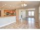 Modern kitchen flowing into a living area, with modern appliances, bar height seating, and recessed lights at 21491 Raccoon Ct, Noblesville, IN 46062