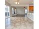 Open-concept living room featuring view to kitchen, fireplace, natural lighting, and sliding door at 21491 Raccoon Ct, Noblesville, IN 46062