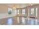 Open-concept living room featuring hardwood floors, wainscoting, and natural light from multiple windows at 21491 Raccoon Ct, Noblesville, IN 46062
