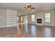 Comfortable living room with a decorative fireplace, built-in shelving, ceiling fan, and sliding doors with view to outdoors at 21491 Raccoon Ct, Noblesville, IN 46062