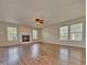 Bright living room featuring a fireplace, ceiling fan, modern flooring, and ample natural light at 21491 Raccoon Ct, Noblesville, IN 46062