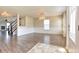 Spacious living room with hardwood floors, wainscoting, and a view of the staircase at 21491 Raccoon Ct, Noblesville, IN 46062