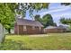 Expansive backyard featuring a well-maintained lawn and mature trees, perfect for outdoor activities at 241 Wehmeier St, Columbus, IN 47201