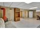 Spacious basement area with retro fireplace, paneled walls, and ample storage space at 241 Wehmeier St, Columbus, IN 47201