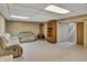 Finished basement with a retro fireplace, comfortable seating, and built-in shelves at 241 Wehmeier St, Columbus, IN 47201