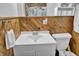 This bathroom features a white vanity with wood paneling and floral shower curtain at 241 Wehmeier St, Columbus, IN 47201