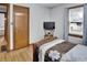 This bedroom features a brown wooden bed frame, wood floors, and a dark wood door at 241 Wehmeier St, Columbus, IN 47201