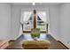 Elegant dining room with a wooden table, classic upholstered chairs, and abundant natural light from the windows at 241 Wehmeier St, Columbus, IN 47201