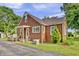 Charming brick home featuring a covered porch, well-maintained yard, and AC unit at 241 Wehmeier St, Columbus, IN 47201