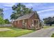 Charming brick home featuring a covered porch, perfect for relaxing outdoors at 241 Wehmeier St, Columbus, IN 47201