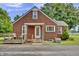 Quaint brick home featuring a covered porch, perfect for relaxing outdoors at 241 Wehmeier St, Columbus, IN 47201
