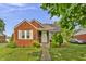 Charming brick home with a well-manicured lawn and inviting front entrance, showcasing curb appeal at 241 Wehmeier St, Columbus, IN 47201