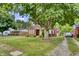 Charming brick home with a well-manicured lawn and a large tree providing ample shade at 241 Wehmeier St, Columbus, IN 47201