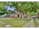 Charming brick home with a well-manicured lawn and a large tree providing ample shade at 241 Wehmeier St, Columbus, IN 47201