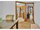 Open-concept floor plan seamlessly connects the dining area, kitchen, and hallway with original hardwood floors at 241 Wehmeier St, Columbus, IN 47201