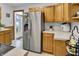 Well-lit kitchen with stainless steel refrigerator, light countertops, and access to backyard, perfect for entertaining at 241 Wehmeier St, Columbus, IN 47201