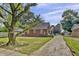 Quaint brick home featuring yard and driveway at 241 Wehmeier St, Columbus, IN 47201