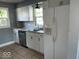 Bright kitchen features white cabinets, stainless steel appliances, and tile backsplash at 2507 S Keystone Ave, Indianapolis, IN 46203